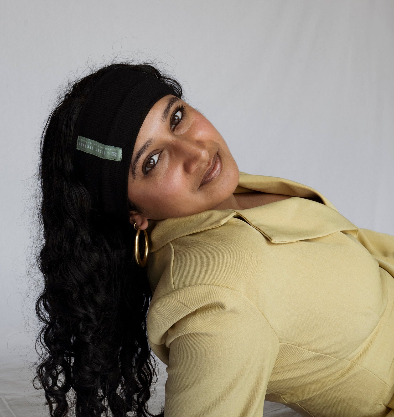 Woman in a yellow outfit posing against a white background
